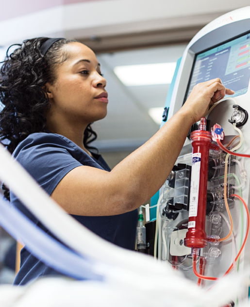 Nurse using the PRISMAFLEX System interface to administer CRRT to ICU Patient.